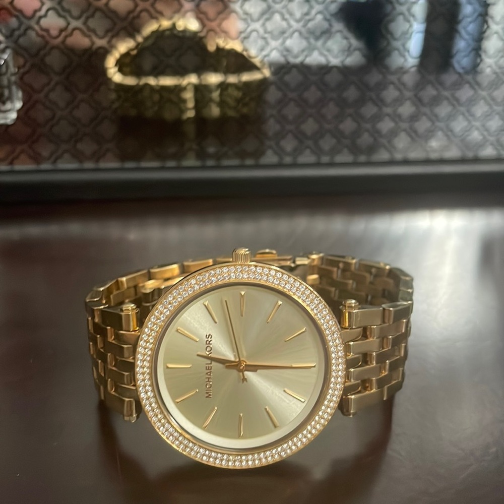 Michael Kors watch in Darci design, gold plated with stone set bezel.